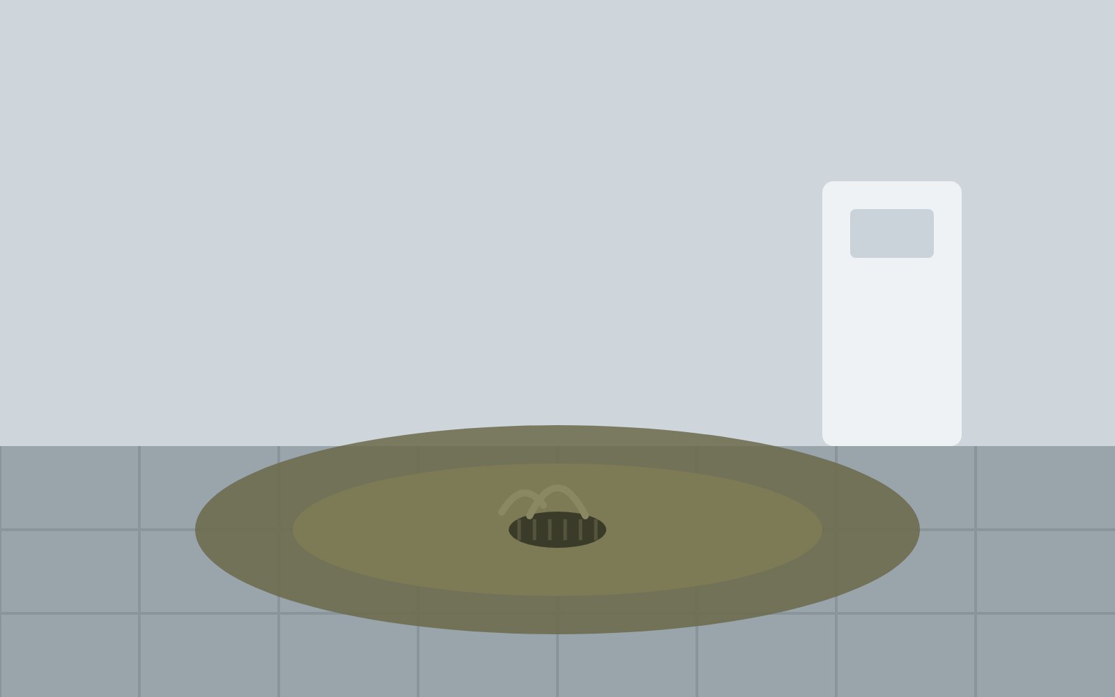 Clogged floor drain with dirty water backup stain on tiled bathroom floor